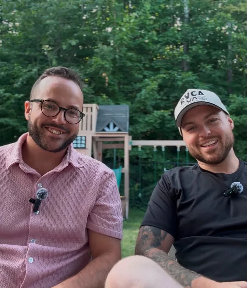 Simon Lafortune and Alexandre Pelletier sitting outside with lapel microphones during a filming session